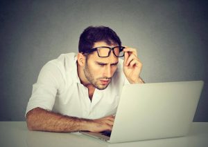 man with laptop suffer astigmatism