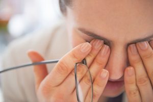 woman suffering from eye pain